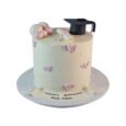 Personalised ivory PhD graduation cake with black mortarboard, rolled diploma, pastel pearl spheres, pink butterflies and custom cake-board message