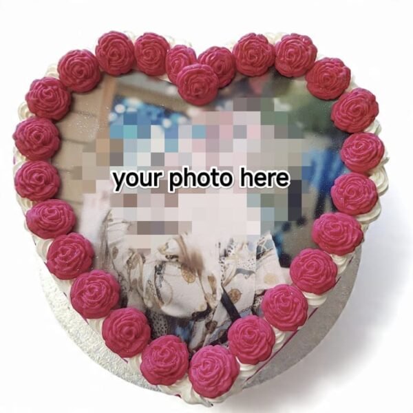 Heart-shaped fresh cream photo cake with custom edible image print, deep-pink piped rose border and white cream edging