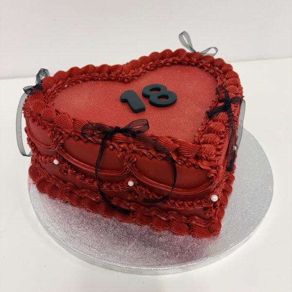 Burgundy vintage Lambeth heart cake with ornate piped swags, shell borders, pearl accents, black ribbon bows and custom number topper
