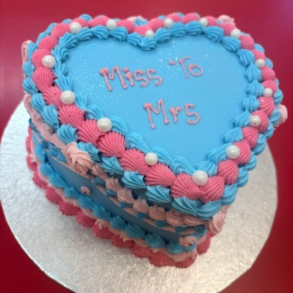 Blue and pink vintage heart cake with layered Lambeth piping, braided borders, white pearl decorations and custom message