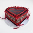 Black and red leopard print heart cake with animal-print sides, braided piped borders, red ribbon bows and a custom message