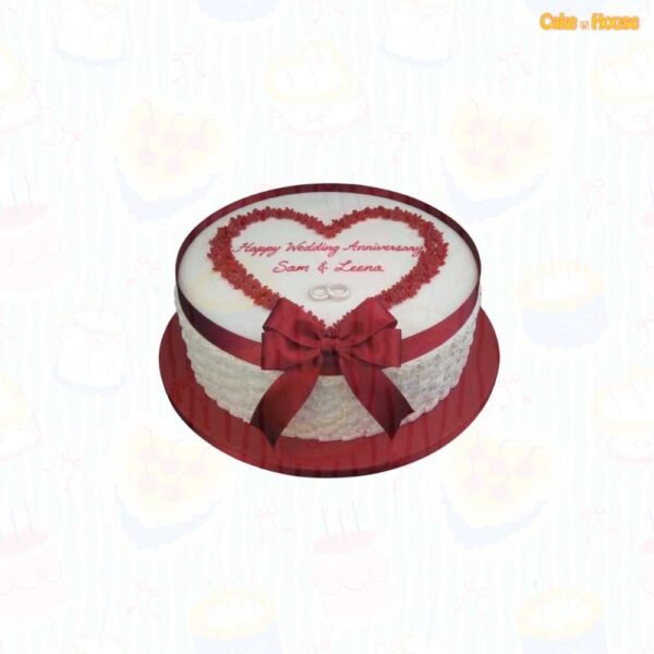 White round wedding anniversary cake with burgundy piped heart frame, custom couple message, silver wedding rings, textured sides and large ribbon bow