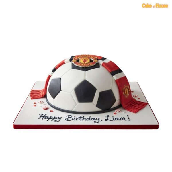 Half football cake shaped as a black-and-white ball with a red Manchester United scarf, club crest and personalised birthday message