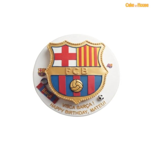 FC Barcelona crest-shaped birthday cake with raised gold, red and blue fondant details, miniature scarf, football and custom message