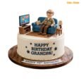 Grandpa Sofa and TV 70th birthday cake with blue armchair, live news TV, remote, mug, side table and personalised birthday message
