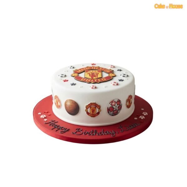 Round white Manchester United football birthday cake with a large club crest, football graphics, miniature balls and red presentation board