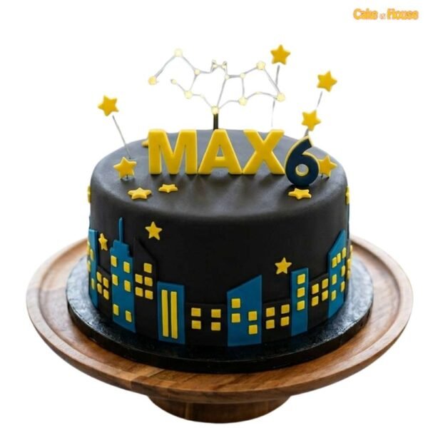 Max Batman Night City birthday cake with black fondant, blue city skyline, yellow stars, bat symbol and personalised name topper