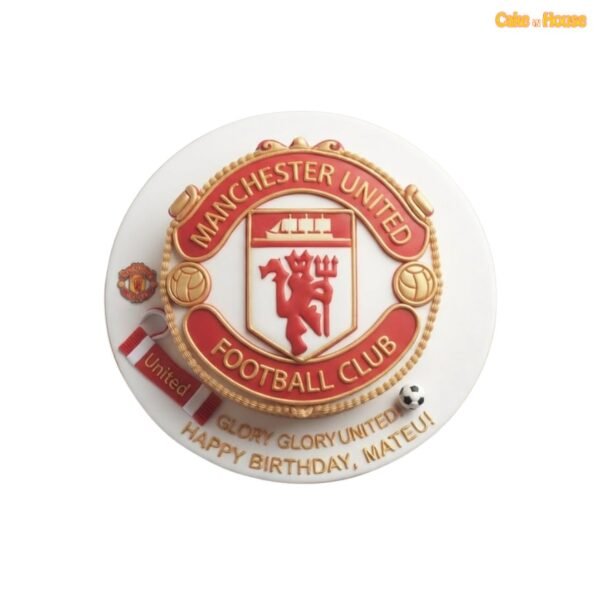 White round Manchester United birthday cake with an oversized red-and-gold club crest, miniature scarf, football and personalised gold message