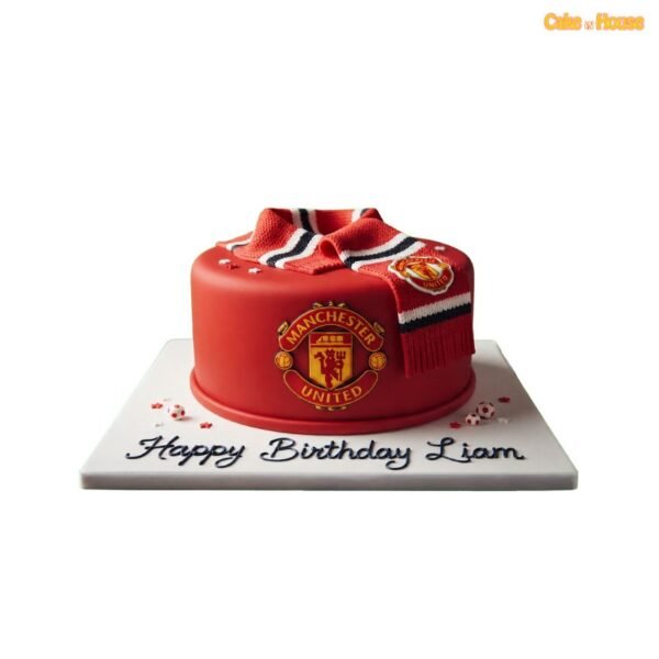 Red round Manchester United birthday cake with a large club crest, realistic team scarf, miniature footballs and custom message