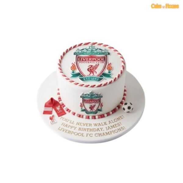 White Liverpool FC birthday cake with club crests on the top and side, red-and-white twisted borders, miniature scarf and football