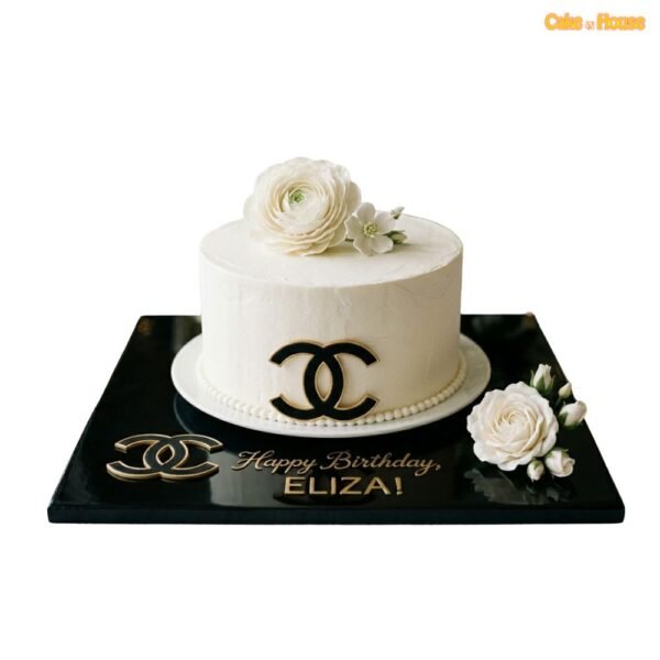 Elegant Chanel rose birthday cake with ivory icing, black and gold CC detail, pearl border, white flower topper and black base