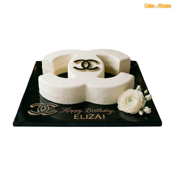 White Chanel CC designer cake with ivory finish, black and gold logo accent, white rose, black board and birthday message