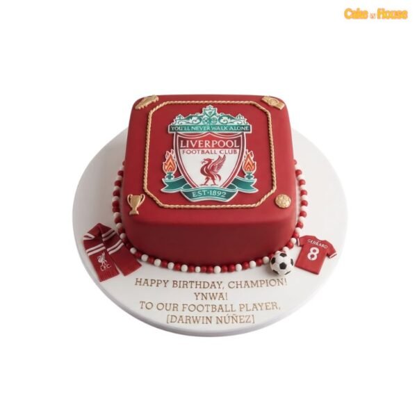 Red square Liverpool FC football cake with large club crest, gold rope border, miniature scarf, football shirt and red-and-white pearl edging