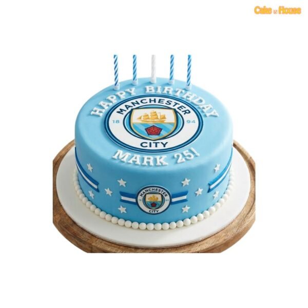 Sky-blue Manchester City birthday cake with large club crest, white stars, blue stripe decorations, white pearl border and custom lettering