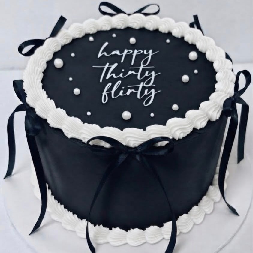 Elegant Black and White Birthday Cake with Bows